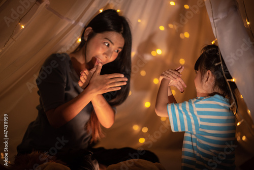 young Asian mother with lit...