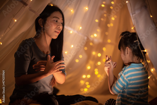 young Asian mother with lit...
