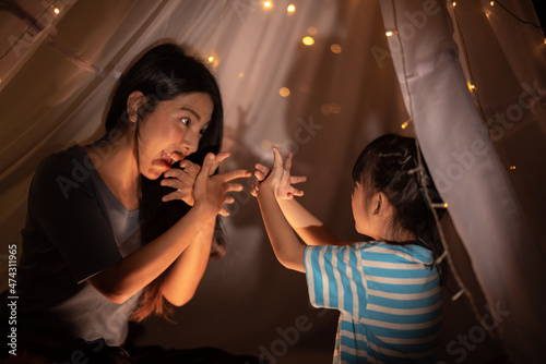 young Asian mother with lit...