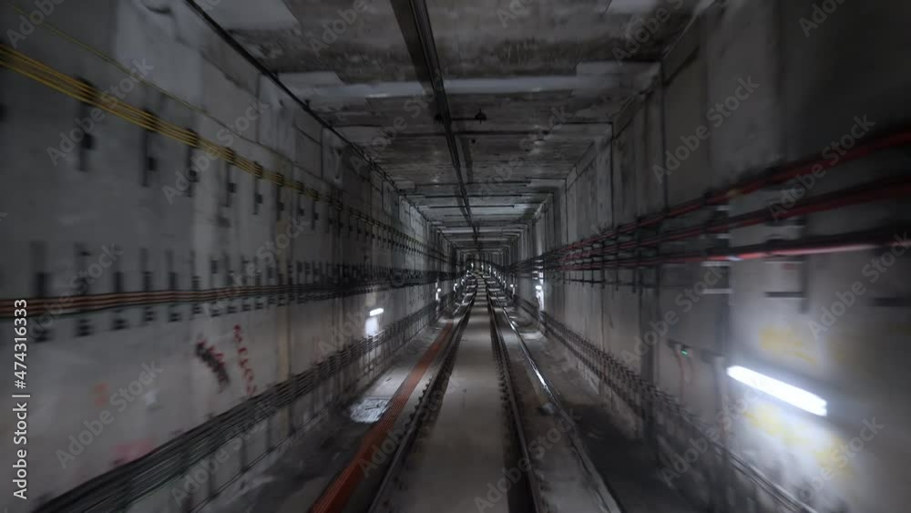Windowless Metro Train Front cabin view of driverless metro train moving forward through ...