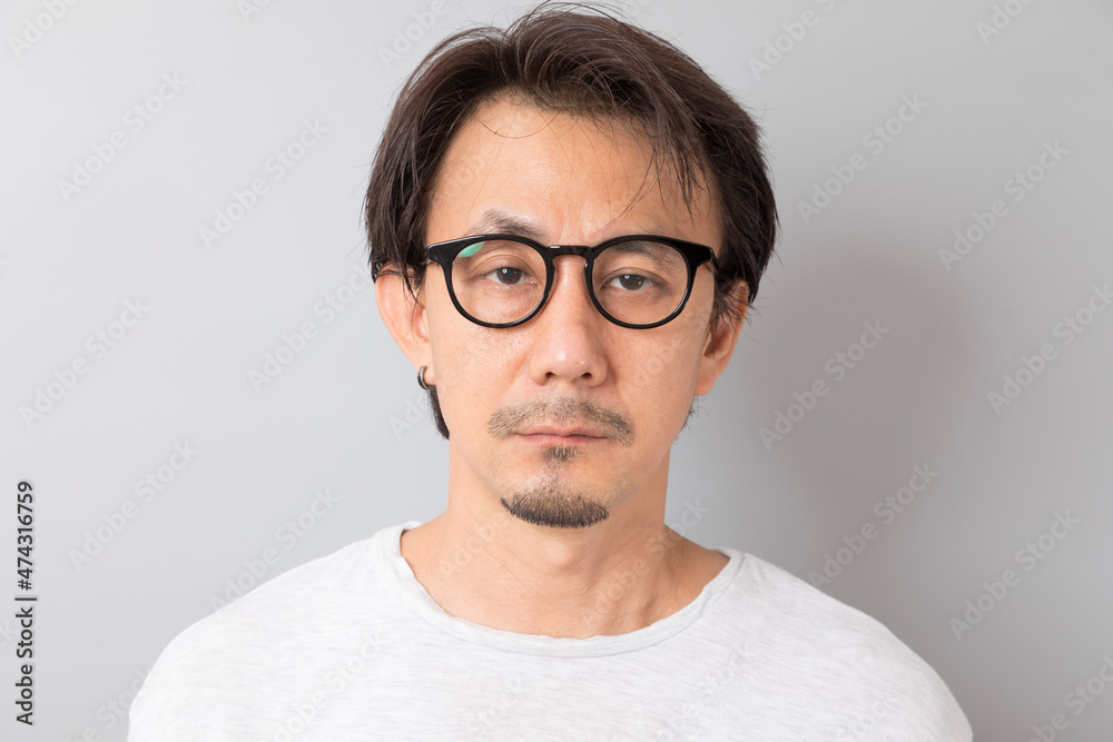 Close up portrait of Asian man wearing eyeglasses on grey background. Close up portrait of Asian man wearing eyeglasses on grey background.