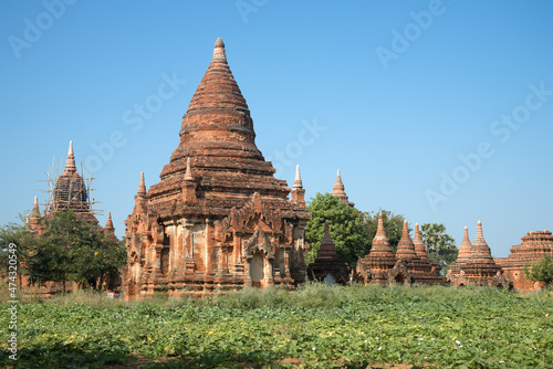 One of the many ancient Buddhist temple complexes on a sunny day. Old Bagan, Myanmar (Burma)