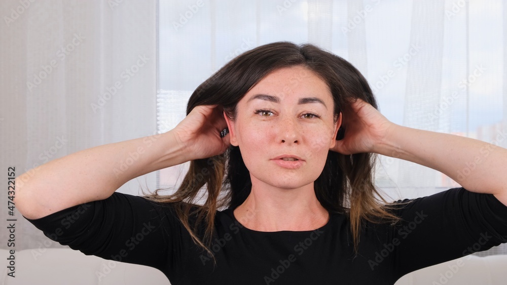 Brunette female makes a head massage and treats herself. Caring for the soul and body. Manage the stress that comes with the end of the year, give yourself time to restore.. Brunette female makes a head massage and treats herself. Caring for the soul and body. Manage the stress that comes with the end of the year, give yourself time to restore..