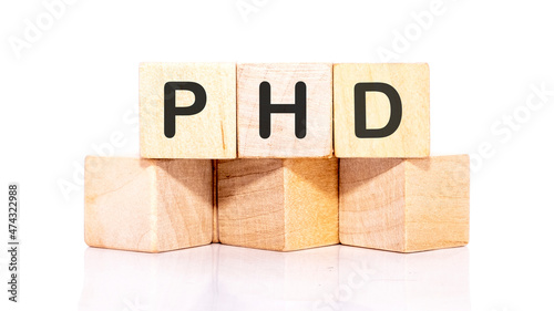 PhD inscription on wooden cubes isolated on a white background photo