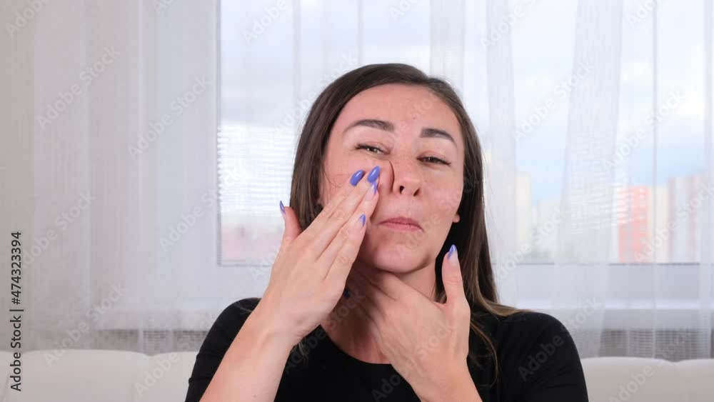 pretty brunette woman makes herself a facial massage along the massage lines and points with her hands. Facial massage. Facial gymnastics. System of exercises improve skin yourself pretty brunette woman makes herself a facial massage along the massage lines and points with her hands. Facial massage. Facial gymnastics. System of exercises improve skin yourself