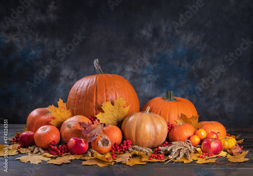 Beautiful autumn still life with pumpkins, wheat, apples and rowan berries. Harvest concept. Halloween