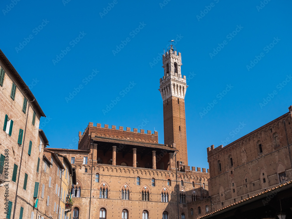 Torre del Mangia and Loggia dei Nove of the Palazzo Pubblico or Palazzo Comunale in Siena. Tuscany, Italy, seen from Piazza del Mercato Square