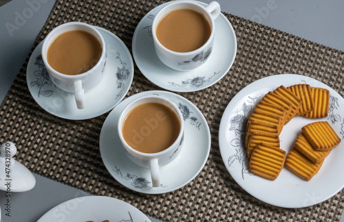 Tea time with Biscuits and dry fruits, White Plan Cashew, and Almonds.
seave in the white marble Tea set.  photo