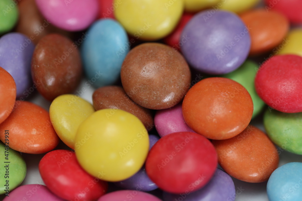 Close-up macro shot of colourful sugar coated chocolate candy sweets, background, texture Close-up macro shot of colourful sugar coated chocolate candy sweets, background, texture