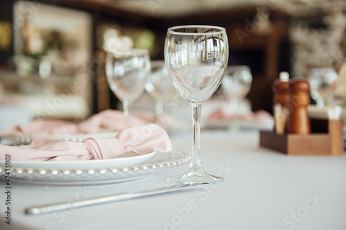 Luxurious restaurant. Luxurious interior, white tables, serving dishes and glasses for guests