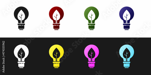 Set Light bulb with leaf icon isolated on black and white background. Eco energy concept. Alternative energy concept. Vector
