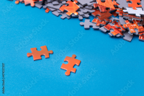 Mixed Peaces of a Colorful Jigsaw Puzzle Lie on the Blue Background - Strategy and Solving Problem Concept © InfinitumProdux