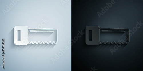 Paper cut Hand saw icon isolated on grey and black background. Paper art style. Vector