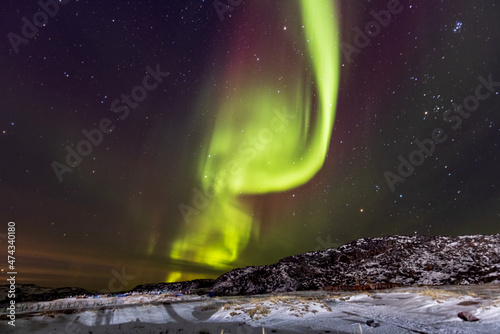 Northern lights with stars. Aurora light. Teriberka village, Murmansk region, Russia.
