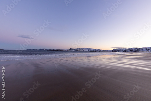 A huge and wide sandy beach of the Arctic Ocean at sunset. Teriberka village  Murmansk region  Russia.