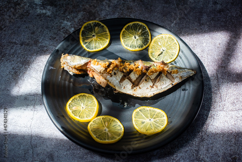 Steamed Rastrelliger kanagurta with garlic main ingredients include fish, garlic, pepper and fish seasoned with sugar, salt... photo