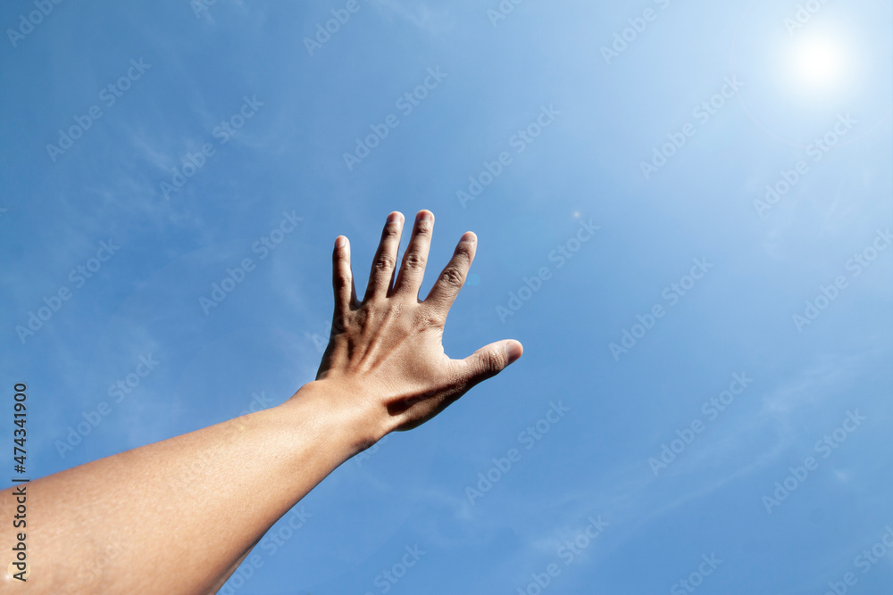 Show Hands outstretched to the sky spread five fingers. With blue sky with sunlight. Show Hands outstretched to the sky spread five fingers. With blue sky with sunlight.