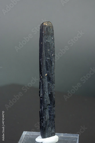 macro mineral stone Ilvaite on a gray background photo