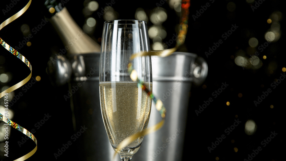 Freeze motion of pouring champagne into flute. Camera movement. Filmed on high speed cinematic camera at 1000 fps.