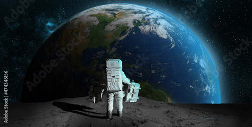 Fototapeta Astronaut on rock surface moon in space