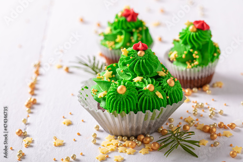 Sweet green cupcakes in the shape of Christmas tree.