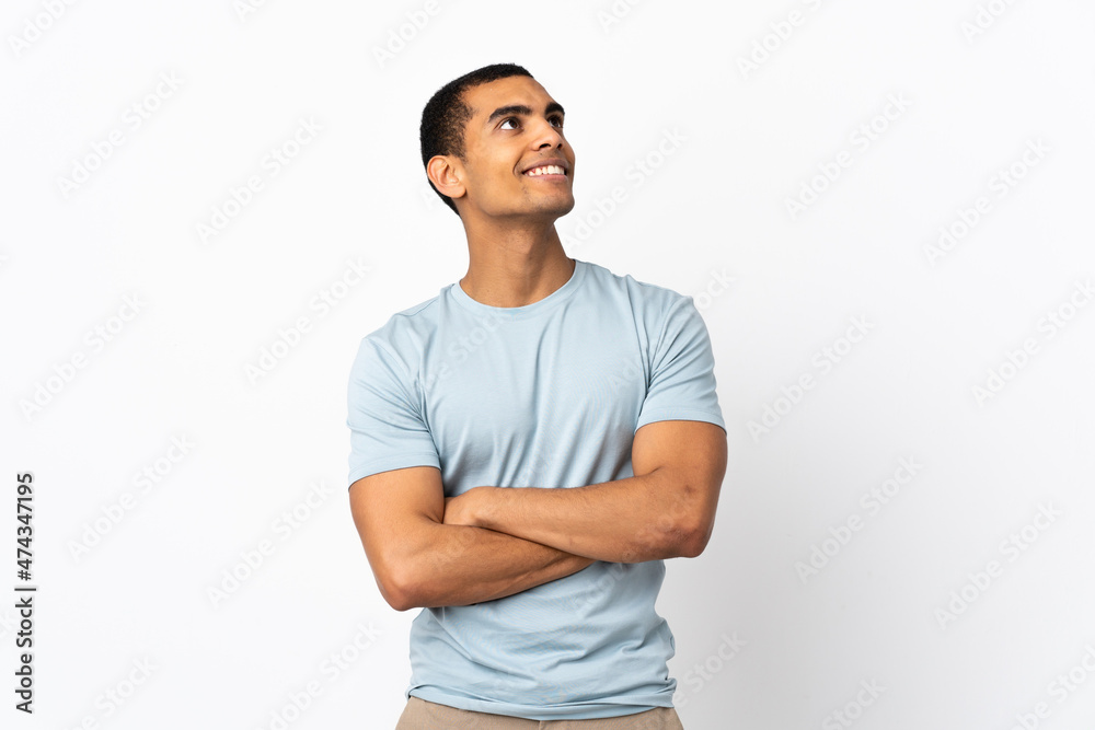 African American man over isolated white background looking up while smiling African American man over isolated white background looking up while smiling