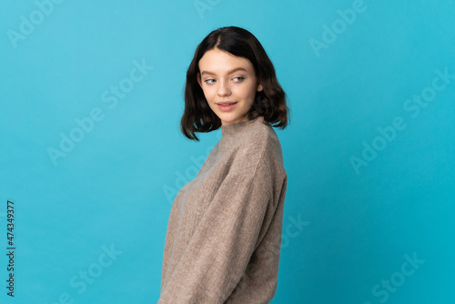 Teenager Ukrainian girl isolated on blue background . Portrait