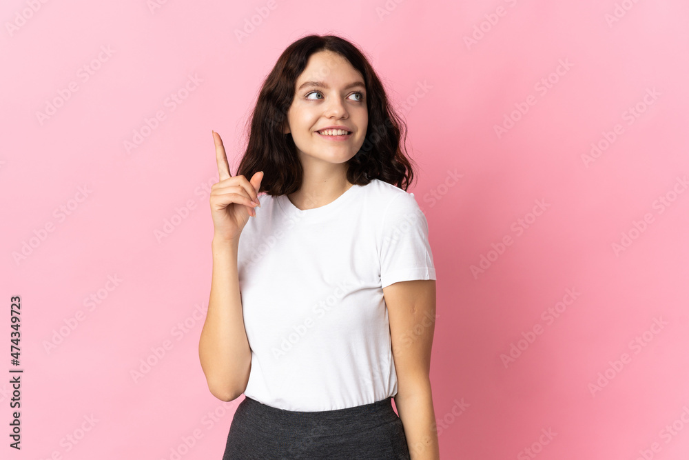 Teenager Ukrainian girl isolated on pink background intending to realizes the solution while lifting a finger up Teenager Ukrainian girl isolated on pink background intending to realizes the solution while lifting a finger up