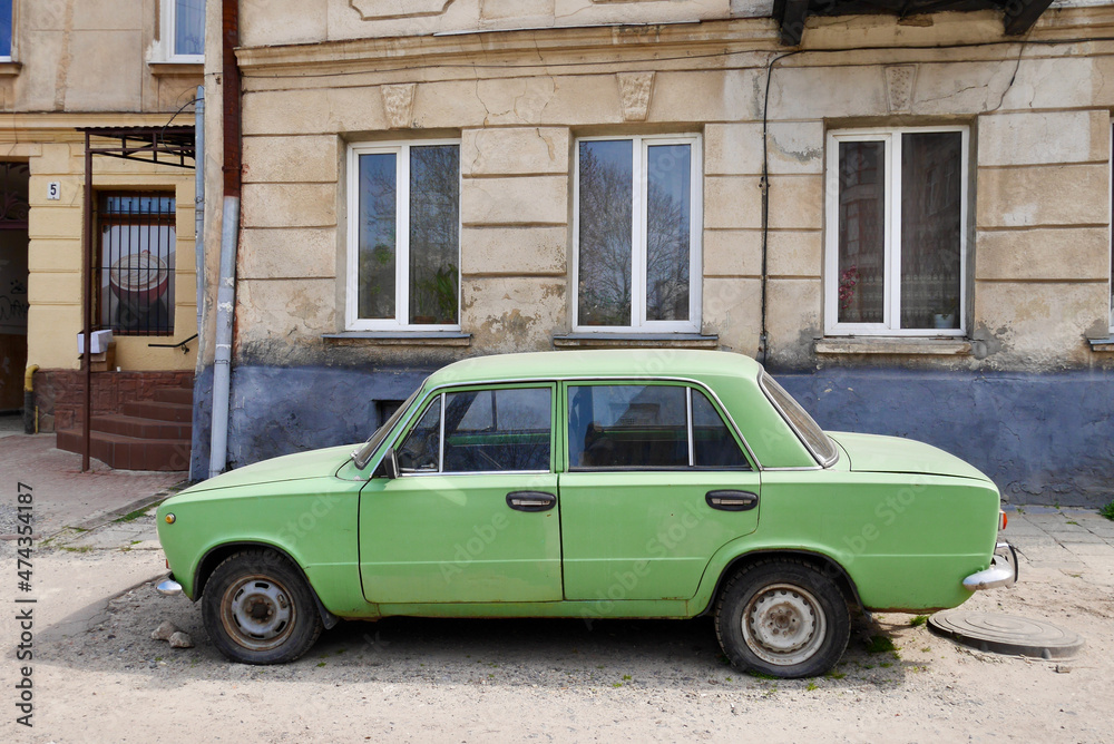Lviv, Ukraine, 8.04.2019. Green vintage car in the streets of Lviv.