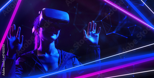 Metaverse virtual event future game entertainment digital technology . Teenager having fun play VR virtual reality glasses sport game metaverse NFT game 3D cyber space futuristic neon background.