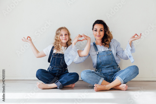 mother and daughter show their heart with their hands