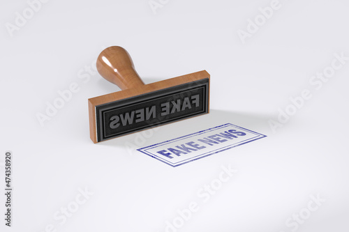 Rubber stamping that says Fake News on White Background. photo