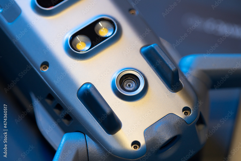 View of the lower part of the drone body, diode illumination,infrared obstacle detection sensors, quadrocopter sensors.Maintenance and repair of the drone. Close-up, in blue. View of the lower part of the drone body, diode illumination,infrared obstacle detection sensors, quadrocopter sensors.Maintenance and repair of the drone. Close-up, in blue.