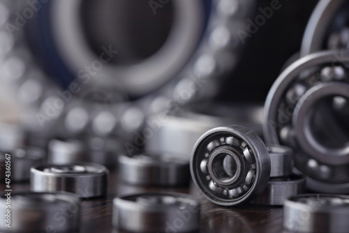 Steel bearing set. Ball radial and tapered plain bearings for mechanical engineering, heavy equipment and machine tools close-up. Spare parts in the form of round bearings of different sizes. photo