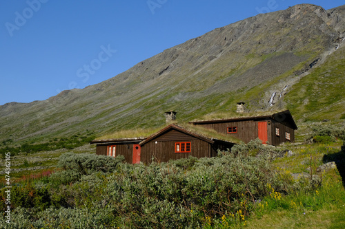 Traditional wooden turf houses in the Norwegian mountains.  Spiterstulen - Norwegian tourist hostel located in Jotunheimen Mountains, in Visdalen valley, on Visa River. Jotunheimen National Park photo