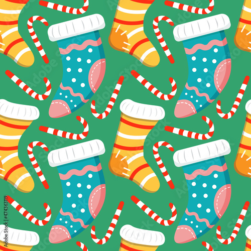 Seamless Christmas background with Christmas Knitted Socks with Patterns and candy cane striped