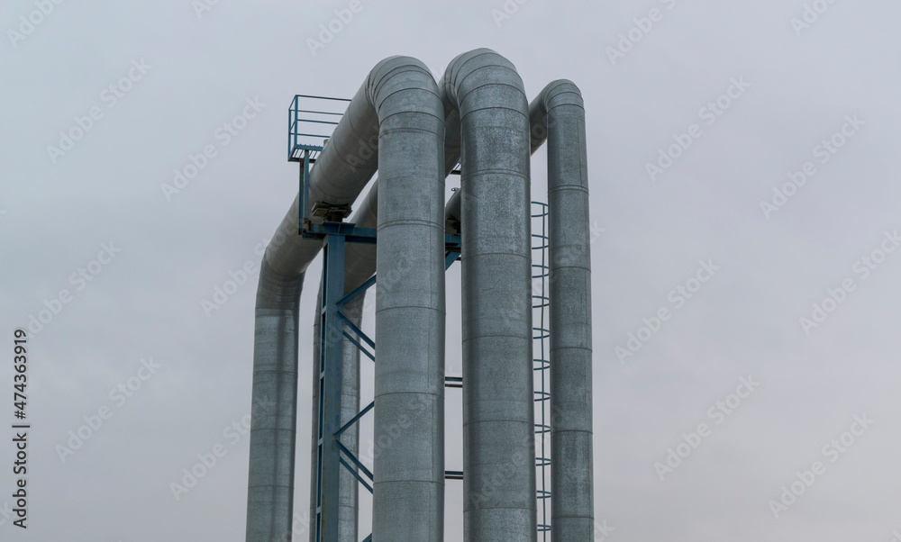 Bending pipes on sky background. Three metal pipes with a service ...