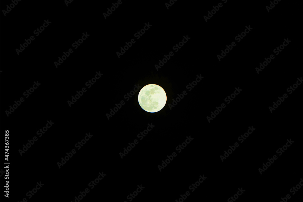 A distant photograph of the green moon on a full moon day. and the dark sky. A distant photograph of the green moon on a full moon day. and the dark sky.