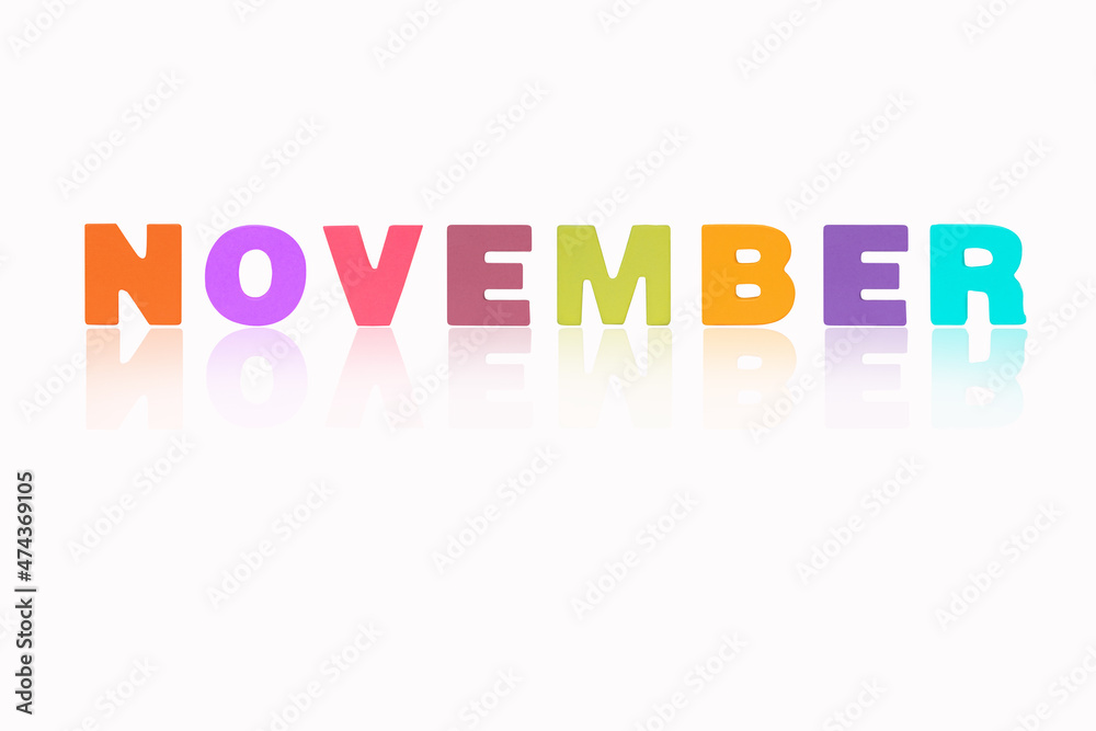 NOVEMBER month English made of wood isolated on white background. Colorful wooden english alphabets set sort. letter made of wood arrange alphabet as categorize word. Poster banner design. NOVEMBER month English made of wood isolated on white background. Colorful wooden english alphabets set sort. letter made of wood arrange alphabet as categorize word. Poster banner design.