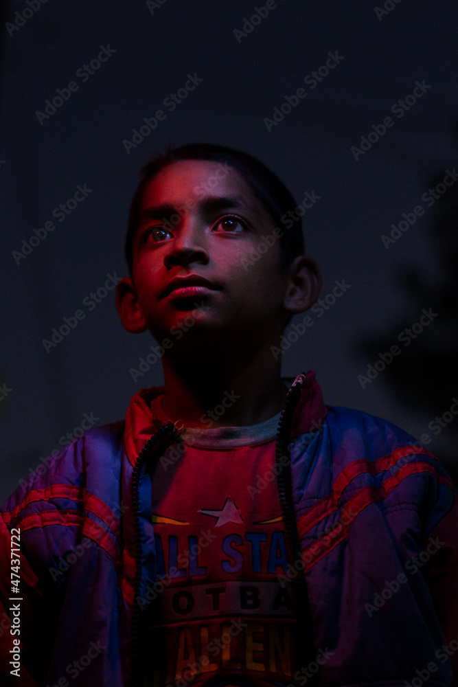 cinematic portrait of a young village boy in the dark