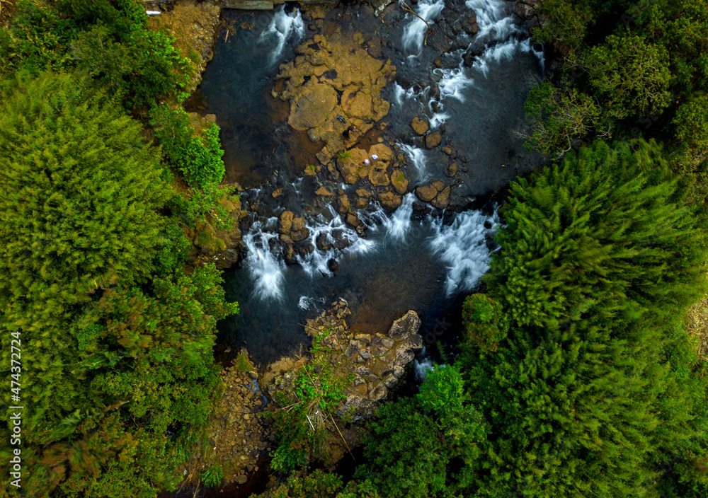 Aerial long exposure view of a hidden waterfall during sunset in Mauritius