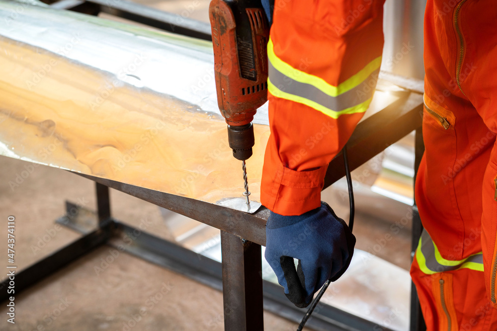 Worker is working with drill. Worker is working with drill.