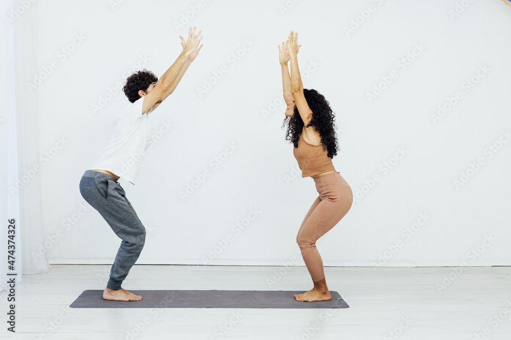 Man and woman doing exercises yoga asana fitness gymnastics Man and woman doing exercises yoga asana fitness gymnastics