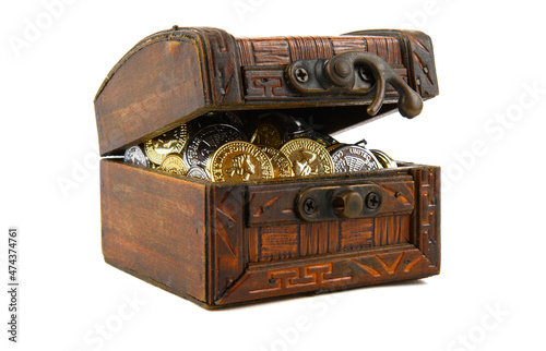 Antique box with a slightly open lid. Silver and gold coins are visible inside