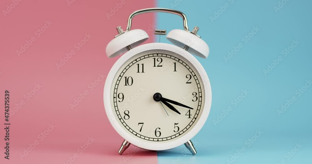 Time-lapse, Modern white clock with long hands turn back to the original number. Set on the two-tone background.