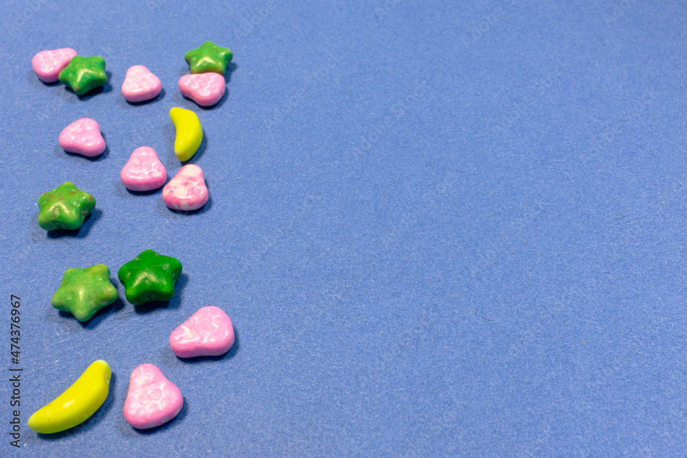 Heap of multicolored tasty candies at the left side of the frame and empty space for your text Heap of multicolored tasty candies at the left side of the frame and empty space for your text