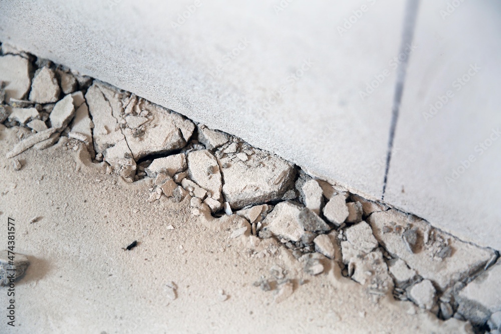 Stones on the floor, broken floor, devastation, screed, flooring repair