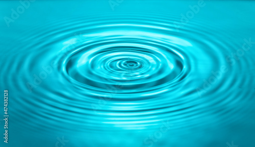 falling drops on the water surface, splash, ripples on the water, blue color