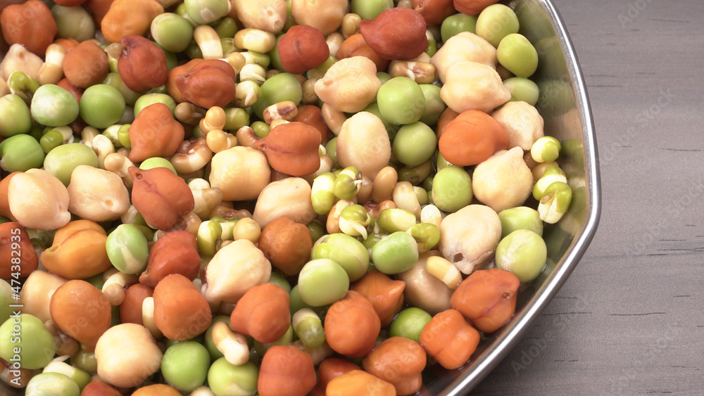 Healthy diet and vegetarian food. Mix of fresh sprouts on beautiful background. macrobiotic food. Sprouted wheat, peas, lentil seeds. Copy space 
