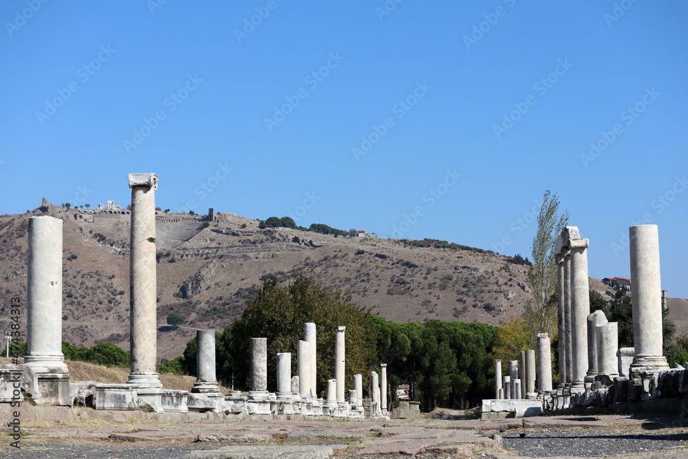 Fototapeta premium scenic view from sanctuary of asclepius to the majestic acropolis with steepest ancient theatre in the world, ruins of Pergamon, Turkey